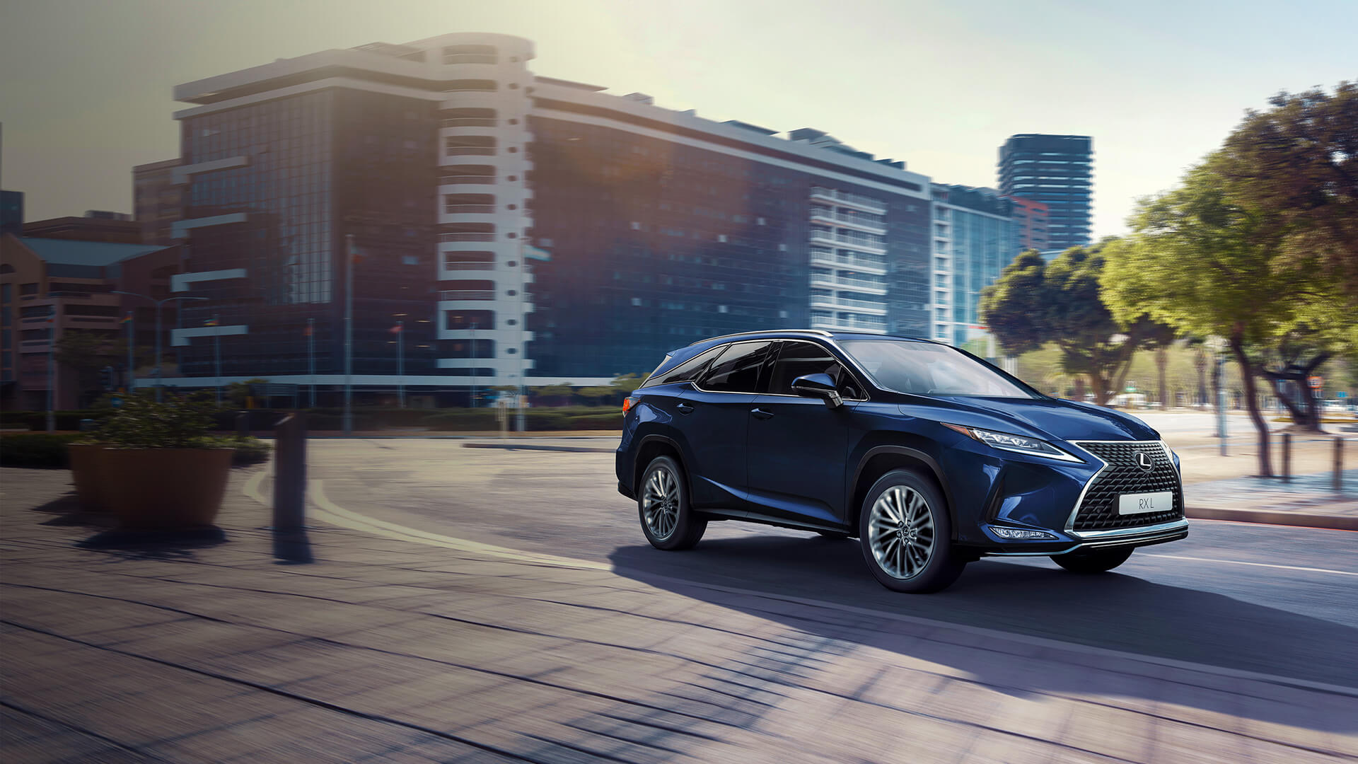 Dark blue Lexus RX driving through the city.