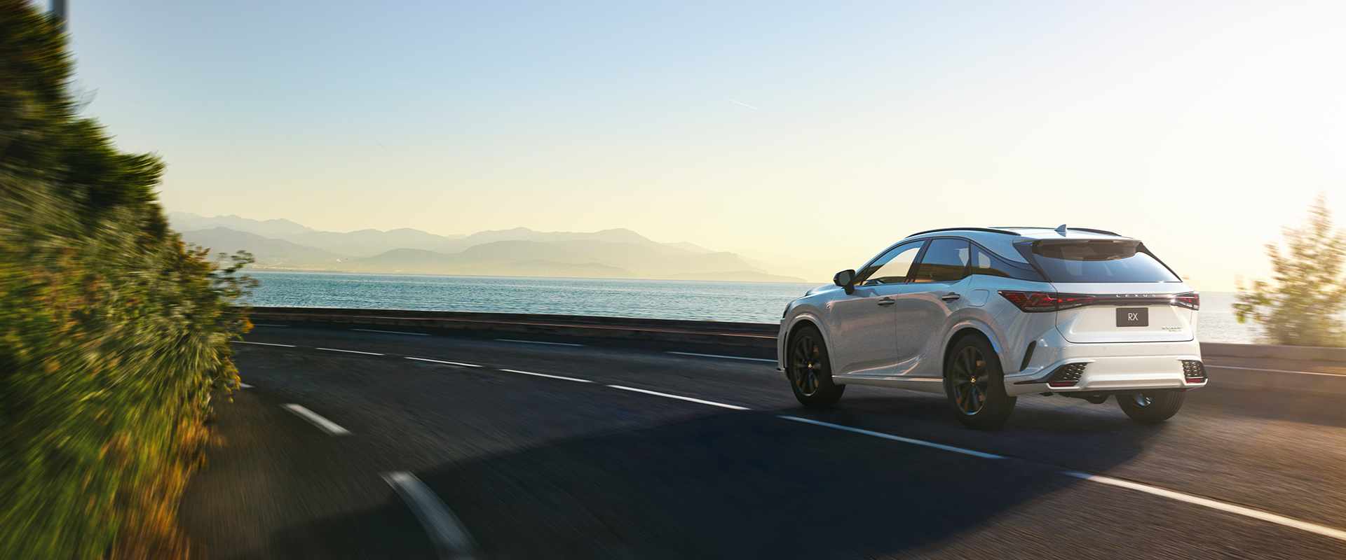 White RX being driven on the road.